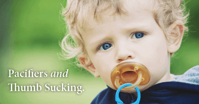 Pacifiers and thumb sucking - young toddler boy with pacifier in mouth