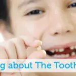 Talking about the Tooth Fairy - little boy holding lost tooth