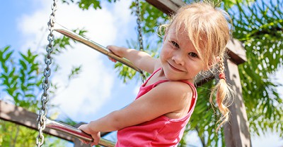 young girl climbing on jungle gym