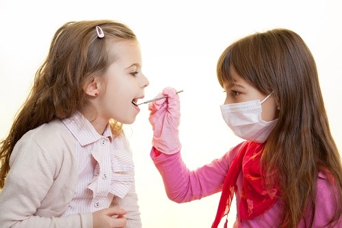 two girls playing dentist