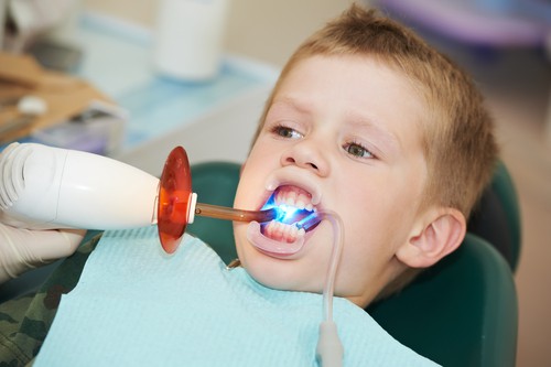 little boy receiving dental filling