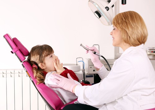 little girl scared in dental chair