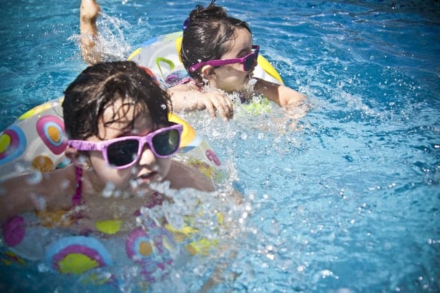 little girls swimming in pool