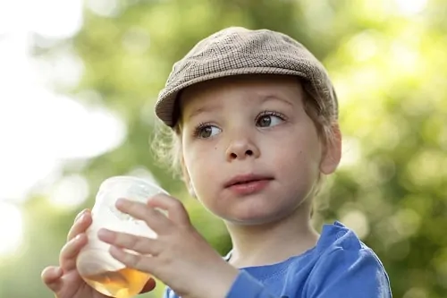 child holding drink